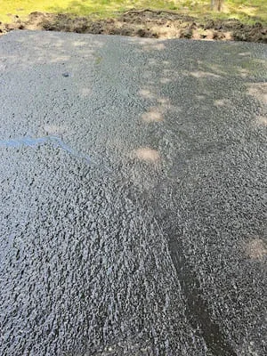 Freshly sealed asphalt surface with dark protective coating and uniform finish