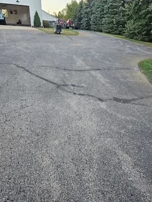 Sealed asphalt driveway with crack repair work completed on residential property